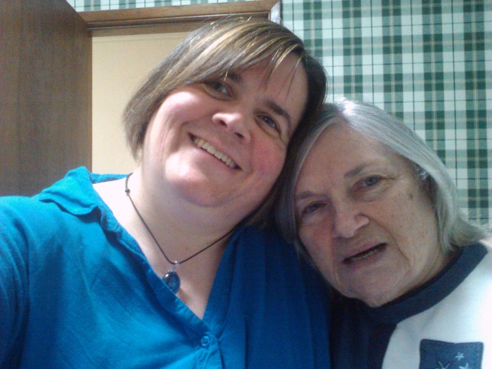 a photo of my mom and I, heads leaned in together with our new haircuts